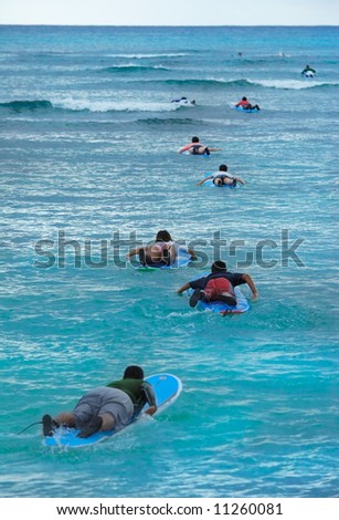 group of people swimming to the surfing place