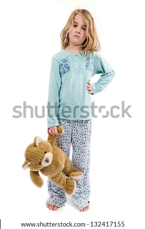 Angry girl in pajamas with teddy bear
