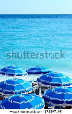 Concept of holiday blue beach with parasols