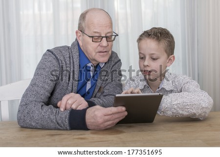 boy and older man on tablet pc