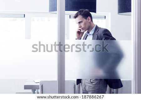 manager in office calling behind glass