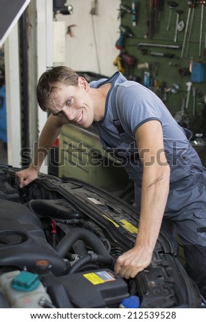 Mechanic repairing a car in the garage