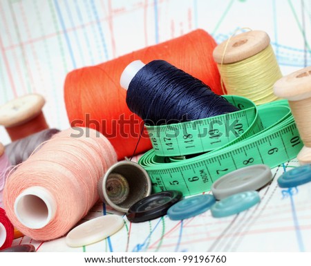 still life of spools of thread on a pattern background