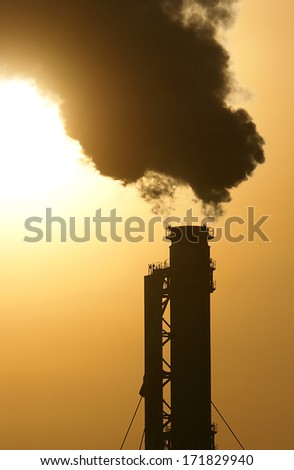 smoking factory chimney in the morning light