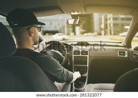 man driving the car in the sunlight