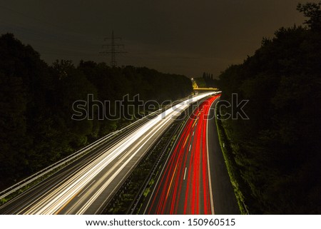 long time exposure on a highway with car light trails at night