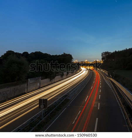 long time exposure on a highway with car light trails on blue hour