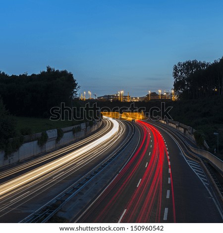 long time exposure on a highway with car light trails on blue hour