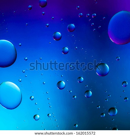 Big waterdrops on blue purple Rainbow gradient background