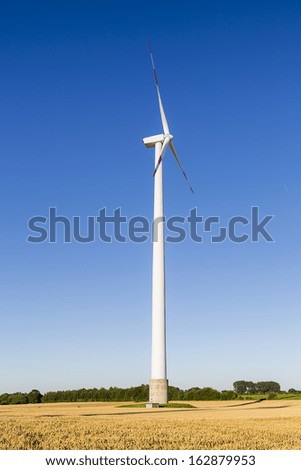 windmill Pinwheel electric wind turbine on Agriculture landscape with blue sky and cornfield