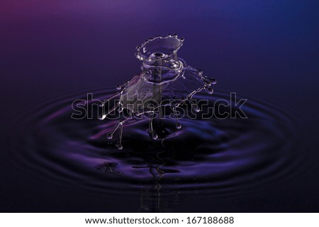 liquid art Water drop collision splash a Liquid Sculpture like a umbrella spinner in purple blue colors