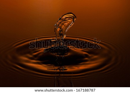 liquid art Water drop collision splash a Liquid Sculpture like a figure in orange red colors