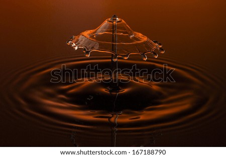 liquid art Water drop collision splash a Liquid Sculpture like a umbrella fungus in orange red colors