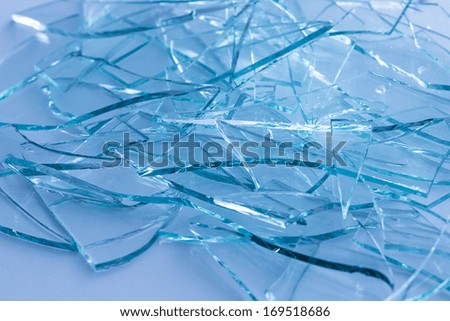 Broken window glas heap on blue gray background