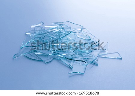 Broken window glas heap on blue gray background