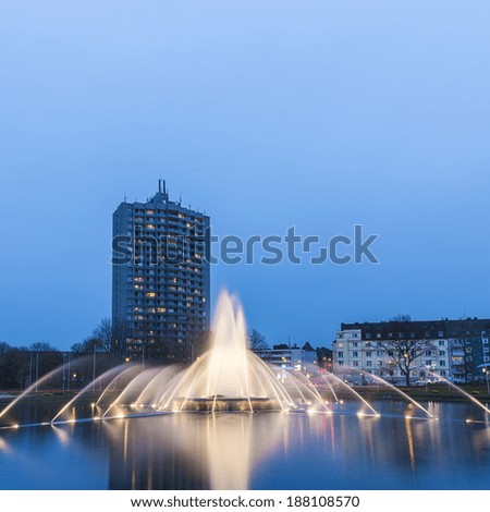 Europaplatz in aachen famous fountain with water fountains at the roundabout at the blue hour Europe Square with skyscraper europahochhaus