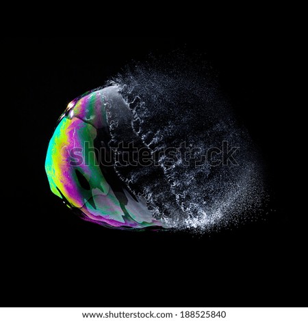 burst Soap Bubble in colorful colors on black background