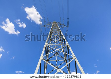 high pipeline pylon energy on blue sky with clouds from a different perspective