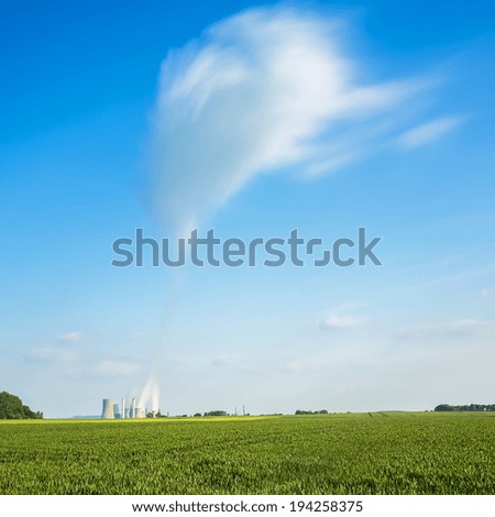 brown cole power station with big cloud in the sky on agriculture landscape