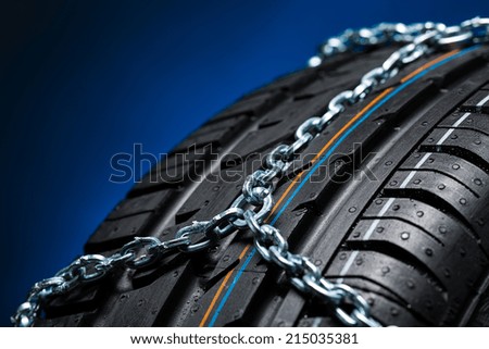 all season tire with snow chains on blue background