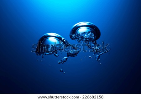 Air bubbles underwater on blue dark background