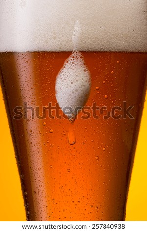 overflowing wheat beer with waterdrops