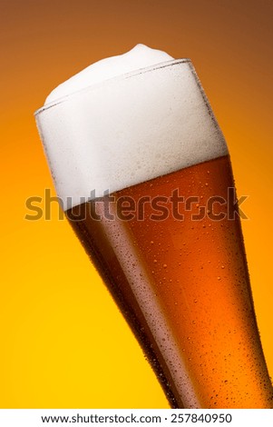 cold german wheat beer in a glass with dew drops