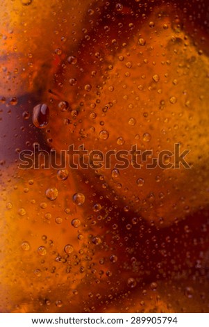 cold cola with dew drops and ice