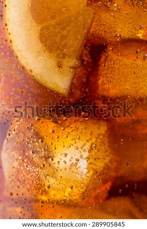 cold coke with ice cubes and dew drops background
