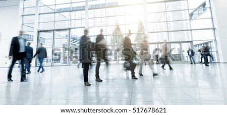 blurred people walking in a modern hall of a Exhibition