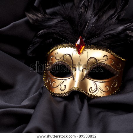 gold mask on black silk