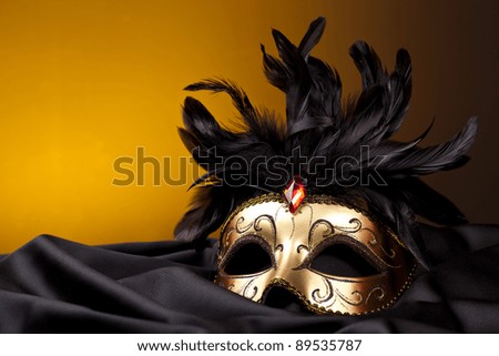 gold mask on black silk