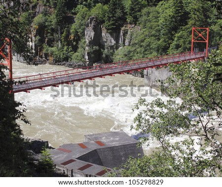 Bridge Spanning the Fraser Valley in southern British Columbia/Bridge and Fraser River/Swift moving FRaser River in British Columbia\'s FRaser Canyon