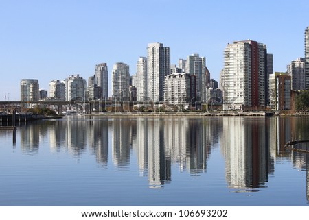 Condominiums and Apartments line the north side of False Creek in Vancouver, British Columbia/Vancouver Hi-Rises/High density living in trendy Vancouver, British Columbia