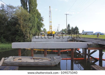 A bridge deck is being assembled for a small bridge spanning a creek in a rural area/Bridge Deck Construction/A bridge deck is being assembled for a small bridge spanning a creek in a rural area.