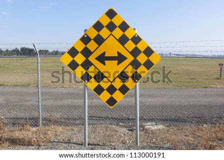 A sign telling drivers they must turn left or right/Turn Left or Right Signage/A sign instructing motorists to either turn left or right