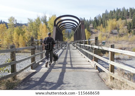 A man walks his dog onto one of many railway bridges near Princeton, British Columbia/Historic Railway Bridges/A historic railway bridge