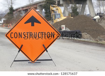 A sign points motorists to nearby bridge construction/Bridge Construction Sign/A construction sign is placed near construction work on a bridge to notify on-coming motorists.