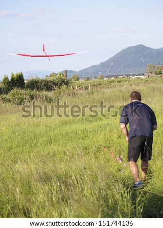A pilot maneuvers his model airplane to a safe landing/Model Airplane/A model airplane is remotely positioned for a perfect landing.
