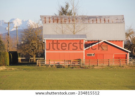 Bright red barn with snow capped mountains in the background/Mountain Barn/Bright red barn with snow capped mountains in the background