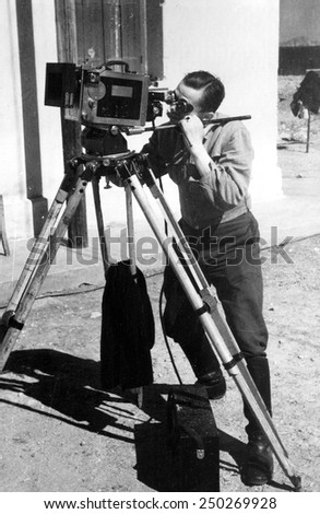 ISLAND OF CRETE/GREECE   JUNE 10, 1941: A film cameraman working for the Nazi's NSDAP party, frames up a shot for a propaganda film on the Island of Crete, Greece on June 10, 1941.