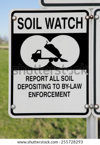 A sign asks local residence to report illegal soil dumping/Soil and Land Protection/A sign asks local residence to report illegal soil dumping.