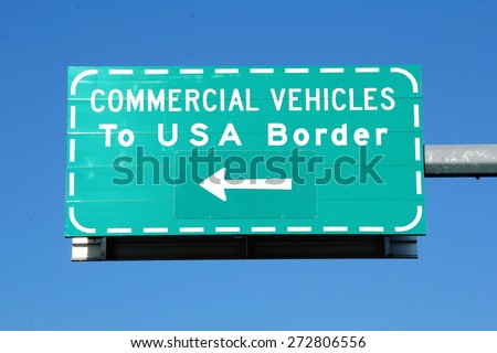 Isolated shot of a sign that directs commercial vehicles to the USA border/Commercial Vehicle USA Border Sign/Isolated shot of a sign that directs commercial vehicles to the USA border