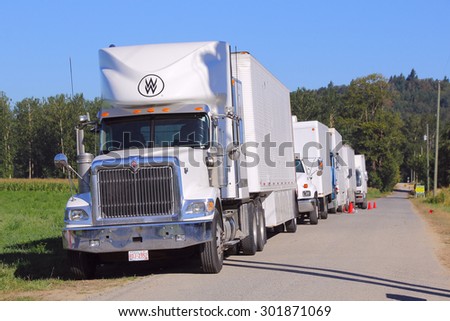 MISSION, BC/CANADA: JULY 31, 2015: Large industrial vehicles used for transporting film and video equipment are parked near the set of Country Girl on July 31, 2015.