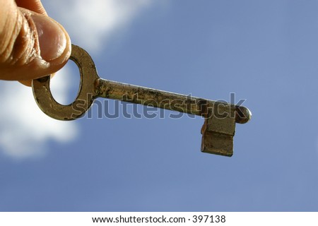 Hand holding key to success