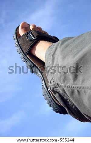 Traveller\'s foot with sandal and blue sky