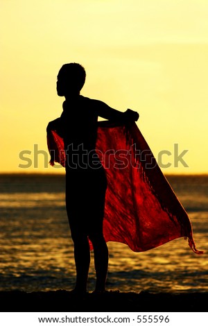 Girl wrapping up with red sarong at sunset