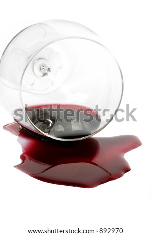 Red wine spilling from glass