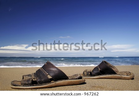 Leather sandals on golden beach