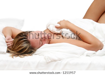 Woman asleep in bed with white linen